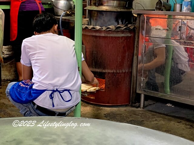 カヤトーストのパンを伝統製法の炭火で焼いているところ